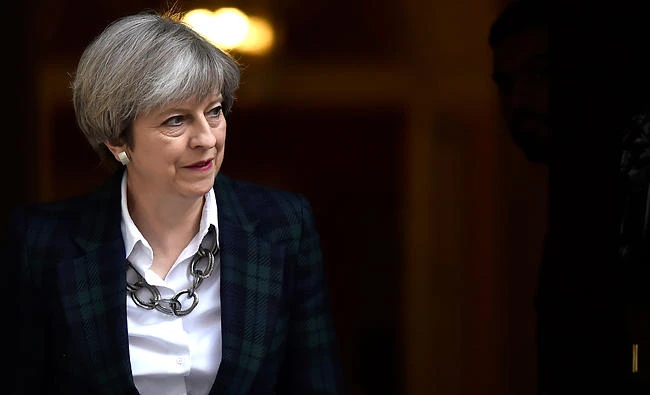 Britain's Prime Minister Theresa May walks out of 10 Downing Street to greet NATO Secretary General Jens Stoltenberg in London, May 10, 2017. REUTERS/Hannah Mckay