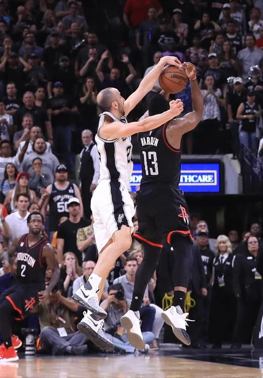 Manu Ginobili of the San Antonio Spurs makes the block against the three-point attempt by James Harden of the Houston Rockets in the final second of play in overtime during Game 5 of the Western Conference Semifinals at AT&T Center on Tuesday in San Antonio, Texas. (AFP)