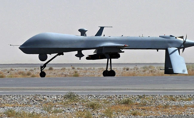This file photo shows a US Predator unmanned drone armed with a missile. Jordanian jets on Wednesday shot down a drone along its border with Syria. (AFP file photo)
