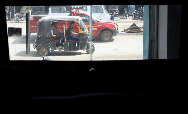 A Tuk Tuk is seen through windows of new "Mini-Car-Egypt" car in a workshop, near Egypt's pyramids of Giza, in Kerdasa, on May 10, 2017. (REUTERS/Amr Abdallah Dalsh)