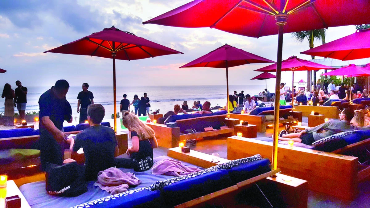 Diners enjoy an evening meal at sunset.