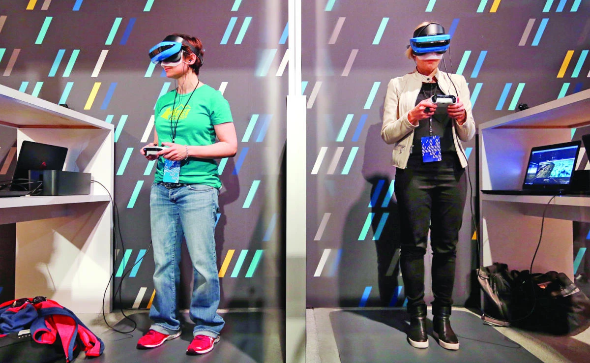 Two women wearing HoloLens devices try out a Windows mixed reality immersive experience at the Microsoft Build 2017 developers conference in Seattle on Wednesday. (AP)