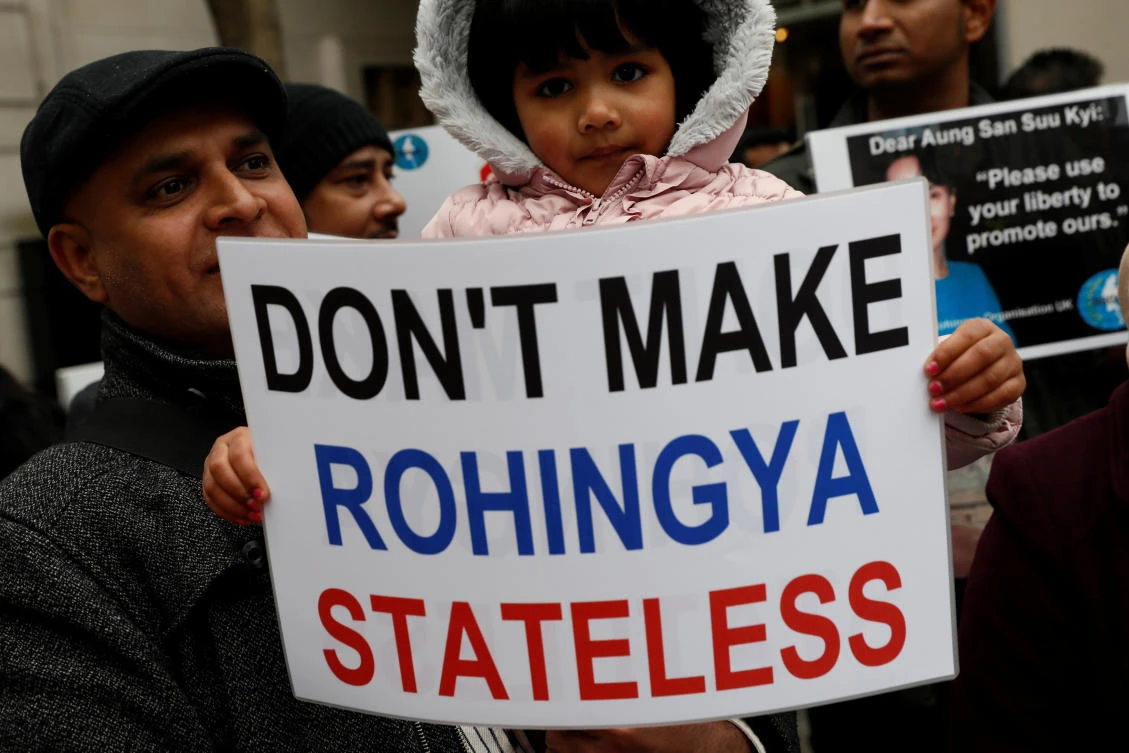 A protester holds a placard as Myanmar's leader Aung San Suu Kyi visits the Guildhall in London, Britain May 8, 2017. (Reuters)