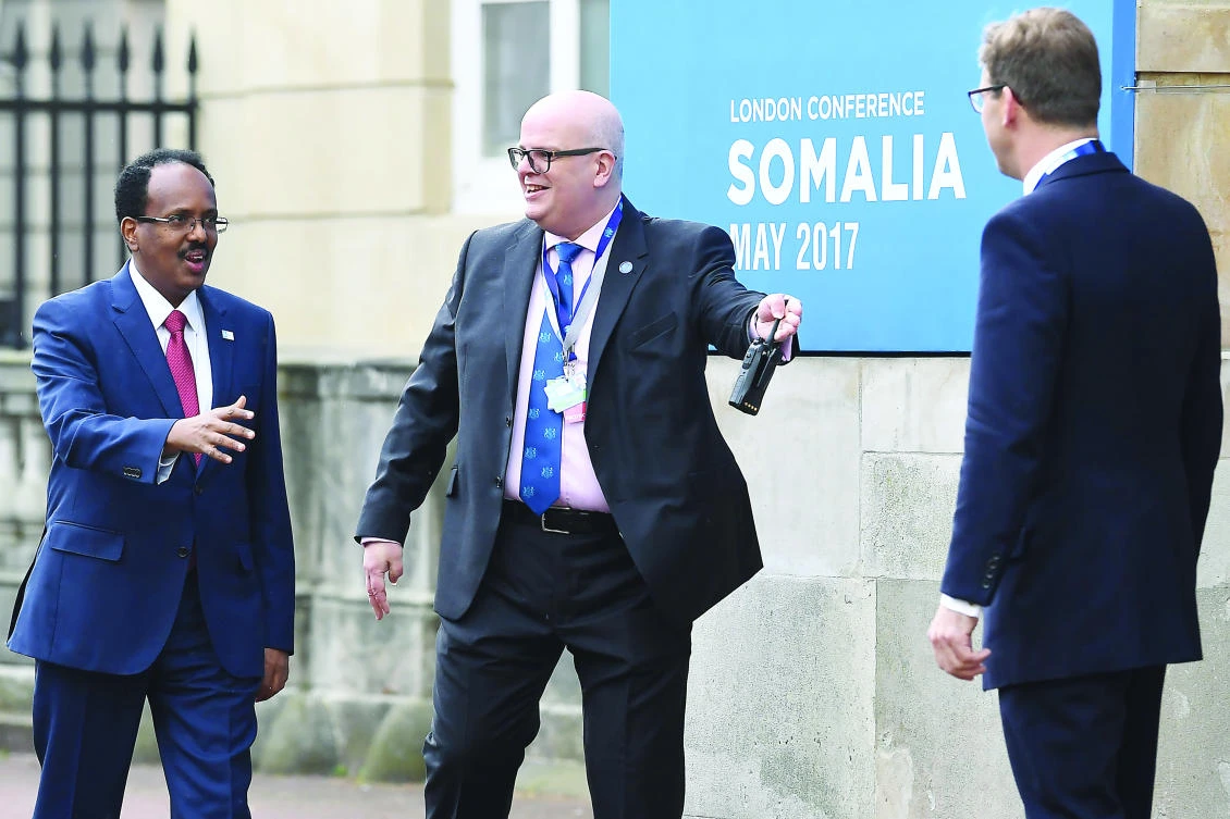 President of Somalia Mohamed Abdullahi Mohamed, left, arrives to attend the London Somalia Conference at Lancaster House in London on Thursday. (AFP)
