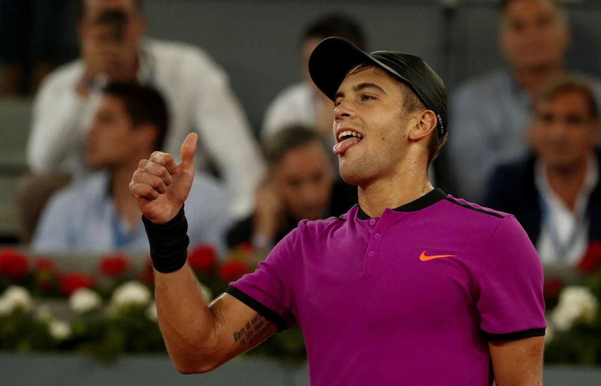 Coric celebrates his victory over Andy Murray in Madrid on Thursday night. (Reuters)