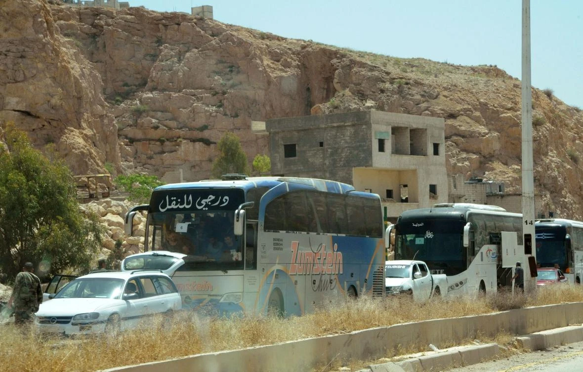 Militants and some of their family members leaving from Damascus' Barzeh neighbourhood. (SANA/AFP)