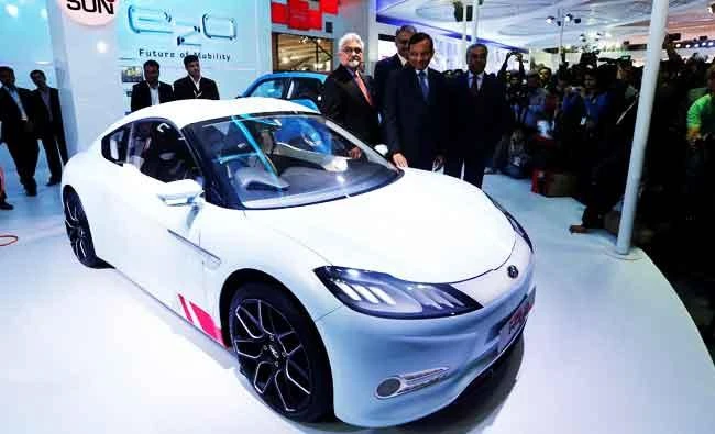 Pawan Goenka (C), president of Mahindra's automotive and farm equipment sectors, stands next to Mahindra's concept electric sports car 'Halo' after its unveiling during the Indian Auto Expo in Greater Noida, on the outskirts of New Delhi, India, in this February 6, 2014 file photo. (REUTERS)