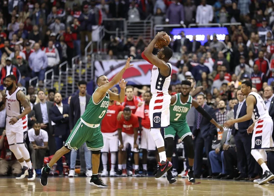 John Wall of the Washington Wizards shoots the game-winning three-point basket against Avery Bradley of the Boston Celtics during Game 6 of the NBA Eastern Conference SemiFinals at Verizon Center on Friday in Washington, DC. (AFP)
