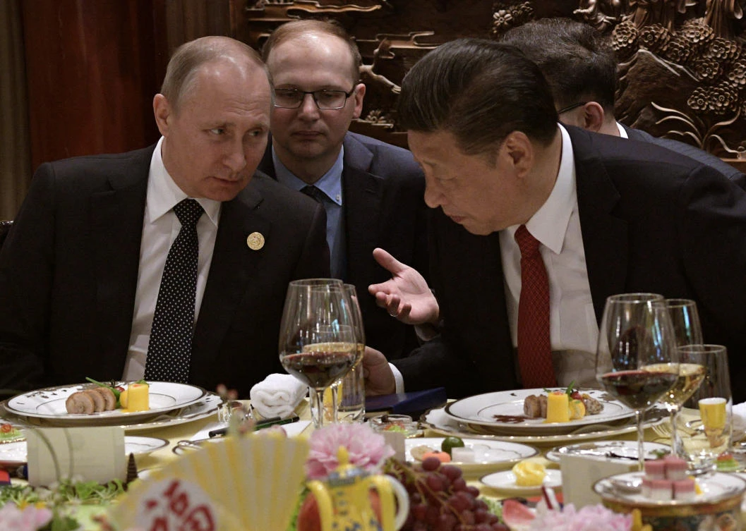 Russian President Vladimir Putin, left, and Chinese President Xi Jinping chat during a breakfast prior to the opening ceremony of the Belt and Road Forum in Beijing, Sunday, May 14, 2017. (AP)