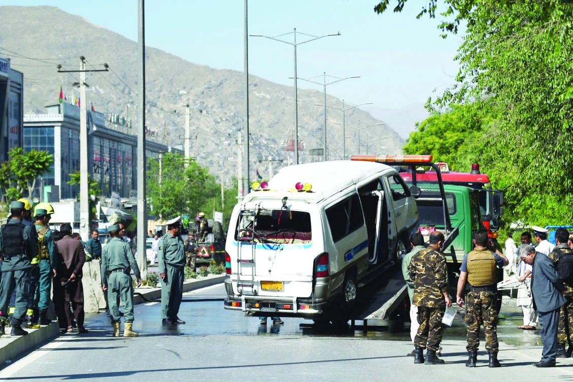 Afghan security personnel remove a damaged vehicle following a bomb explosion in Kabul on Saturday. (AFP)