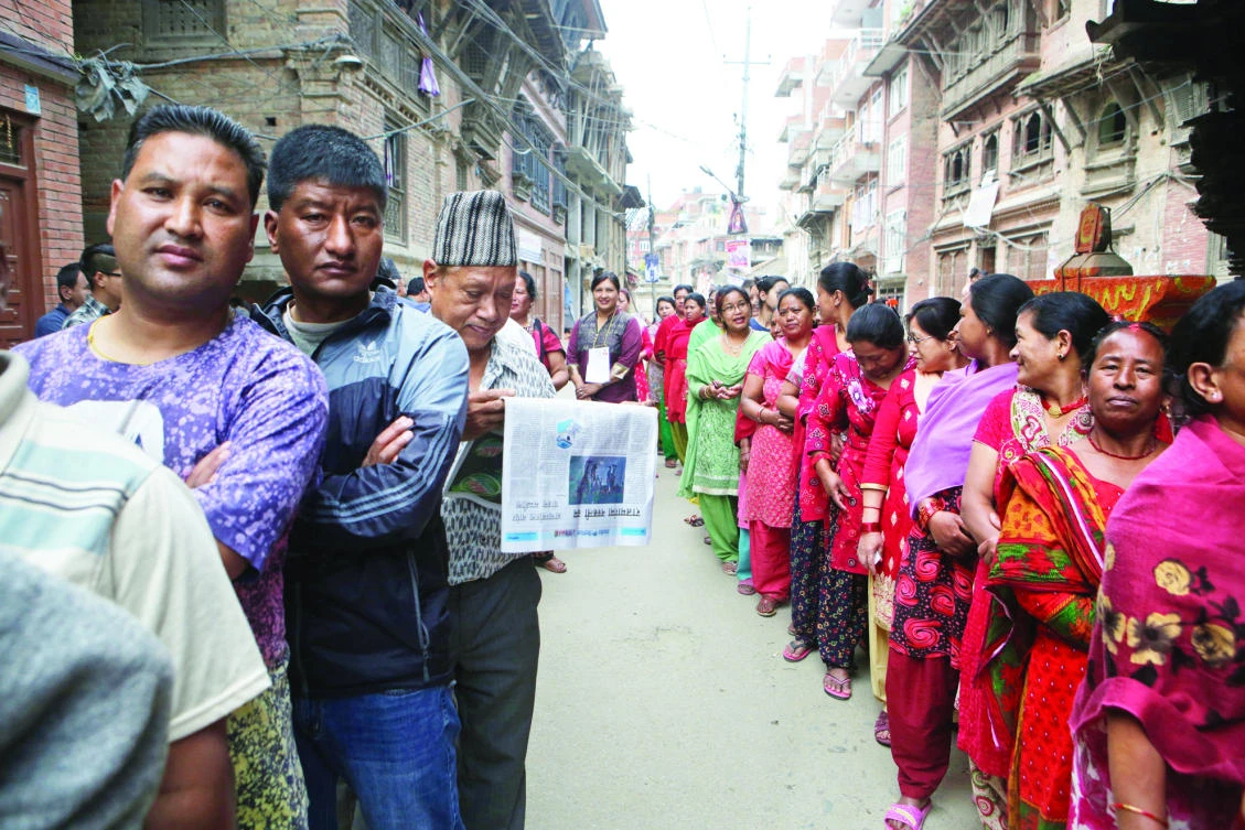 Nepalese voters stand in a queue to cast their votes at a polling station in Bhaktapur, Nepal, on Sunday. (AP)