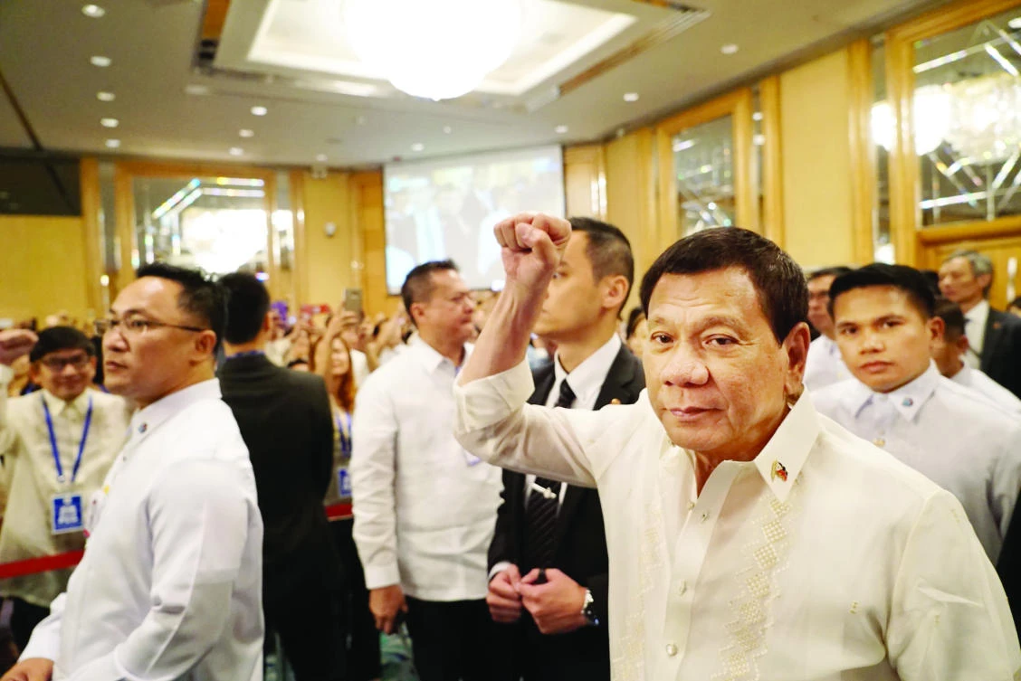 Philippine President Rodrigo Duterte gestures as he arrives to meet the Filipino community in Hong Kong, on Saturday. (Reuters)