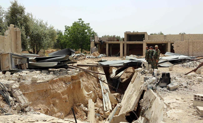 Syrian government forces inspect a destroyed tunnel in Damascus' north eastern al-Qaboun suburb on Sunday after aleast 1,500 civilians and armed fighters were evacuated from the opposition-controlled district. (AFP)
