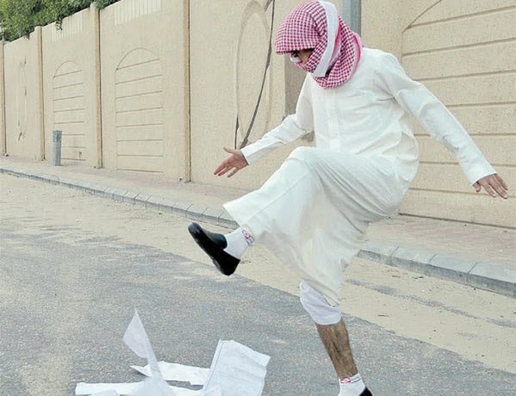 A student stomps on his textbooks on the last day of school. (Photo courtesy: Al-Yaum Saudi newspaper)