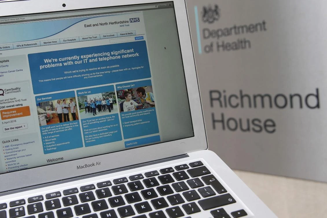 This photograph, posed as an illustration on May 12, 2017, shows the website of the NHS: East and North Hertfordshire notifying users of a problem in its network taken outside the Department of Health in London. Britain's state-run National Health Service was affected by the attack. (AFP)