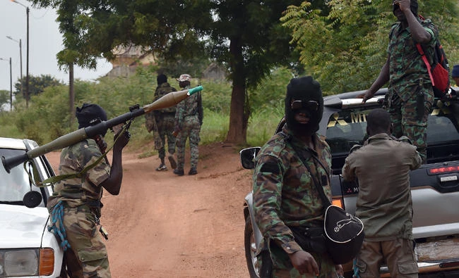 Mutinous soldiers hold an RPG rocket launcher inside a military camp in Ivory Coast's central second city Bouake on Monday. (AFP / ISSOUF SANOGO)