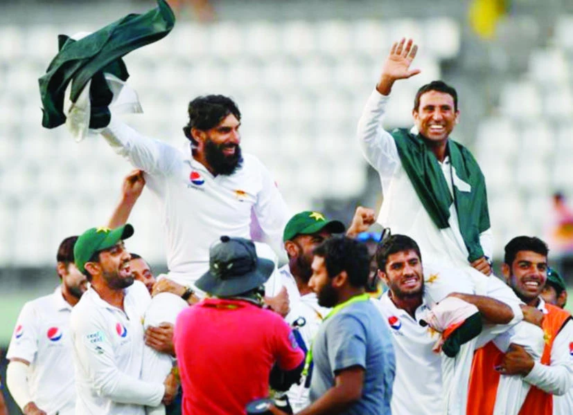 Retiring Pakistan cricket team members captain Misbah-ul-Haq, left, and Younis Khan, right, are carried by teammates as they celebrate after winning the final Test match and the series 2-1 against the West Indies at the Windsor Park Stadium in Roseau, Dominica on Sunday. (AFP)