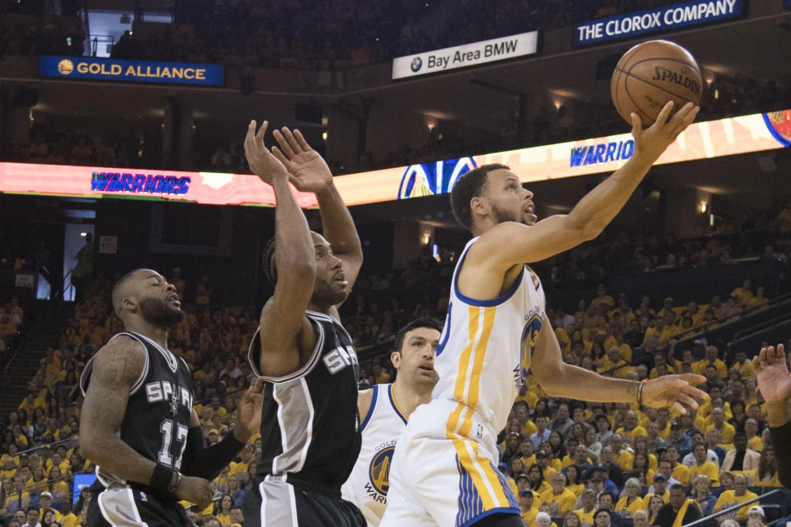 Golden State Warriors guard Stephen Curry shoots the basketball against San Antonio Spurs forward Kawhi Leonard (2) during the second quarter in Game 1 of the Western Conference finals of the 2017 NBA Playoffs at Oracle Arena on Sunday. (USA TODAY Sports)