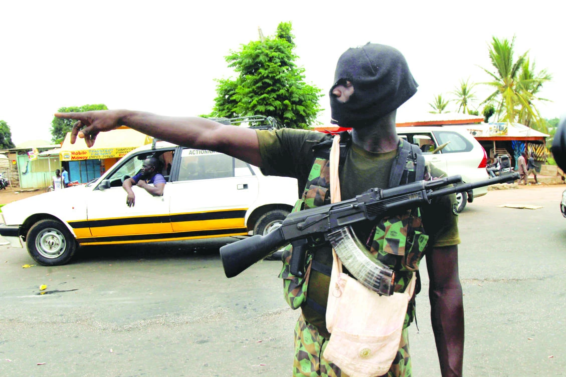 A mutinying soldier stands alert at a checkpoint in Bouake, Ivory Coast, on Monday. (Reuters)