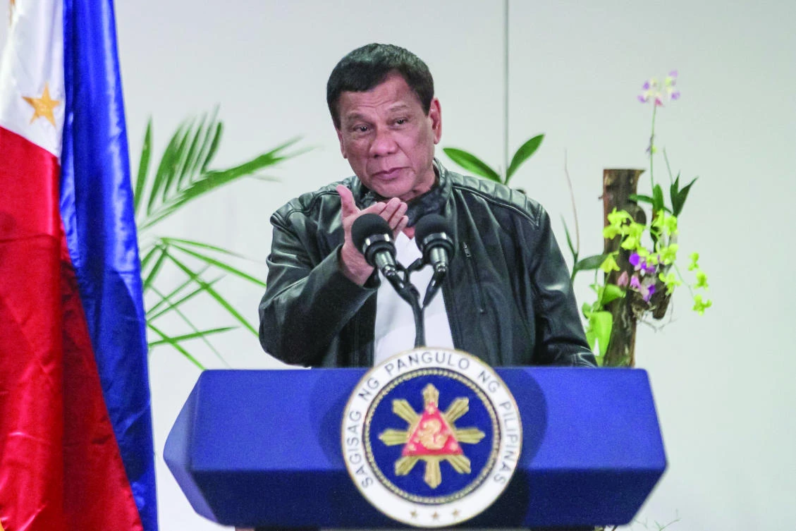 Philippine President Rodrigo Duterte gestures as he speaks shortly after arriving in Davao from a working visit to China. (AFP)