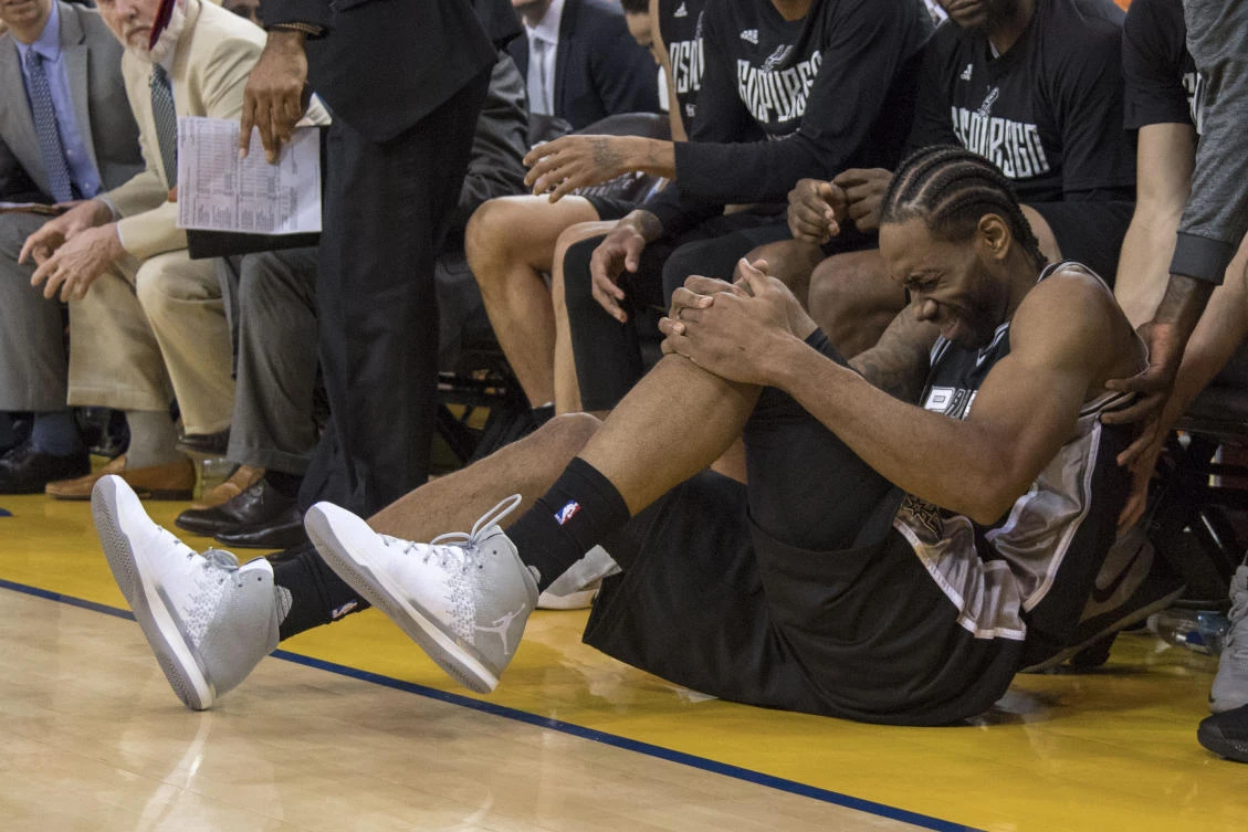 San Antonio Spurs forward Kawhi Leonard reacts after an injury during the third quarter in Game 1 of the Western Conference finals of the 2017 NBA Playoffs against the Golden State Warriors at Oracle Arena on Sunday. (USA TODAY Sports)