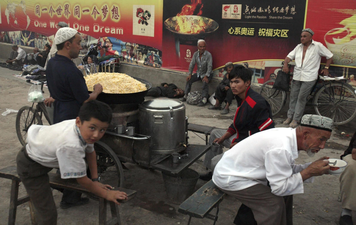 Uighurs rest near a food stall in Kashgar, Xinjiang province in this Aug. 6, 2008 file photo. (AP)
