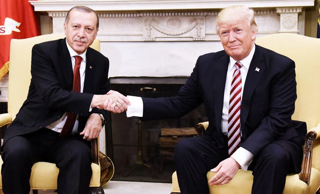 US President Donald Trump shakes hands with Turkish President Recep Tayyip Erdogan during a meeting in the Oval Office of the White House in Washington, DC, on Tuesday. (AFP)