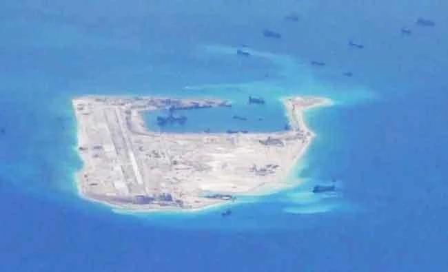 Chinese dredging vessels are purportedly seen in the waters around Fiery Cross Reef in the disputed Spratly Islands in the South China Sea in this still image from video taken by a P-8A Poseidon surveillance aircraft provided by the United States Navy on May 21, 2015. (Reuters)