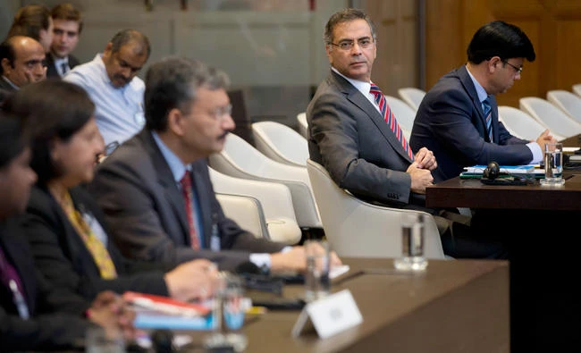 Moazzam Ahmad Khan, head of Pakistan’s delegation and ambassador, second right, and Dr. Deepak Mittal, joint secretary of India’s Ministry of External Affairs, front row third from left, wait for judges to enter and read the World Court’s verdict in The Hague on Thursday. (AP)