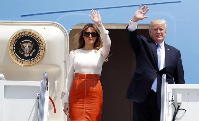 President Donald Trump and first lady Melania Trump, wave as they board Air Force One at Andrews Air Force Base in the US state of Maryland on Friday,prior to his departure on his first overseas trip. (AP Photo/Alex Brandon)