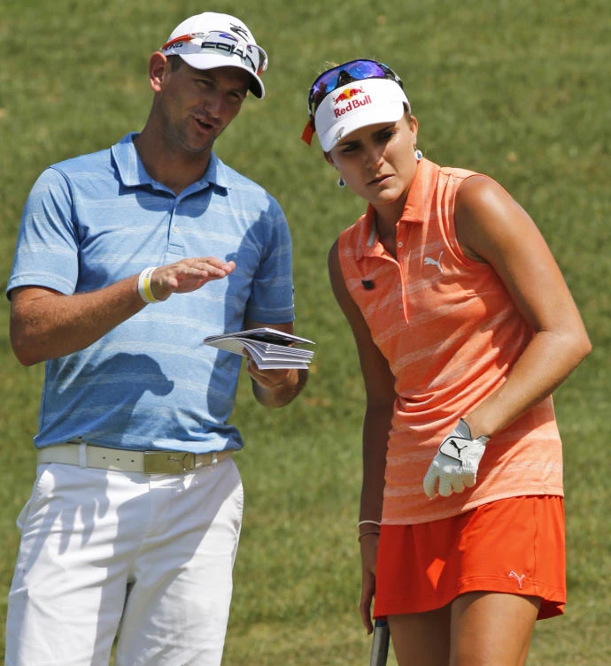 Lexi Thompson, right, talks with her caddie, Kevin McAlpine, on the eighth hole during the second round of the Kingsmill Championship LPGA golf tournament in Williamsburg, Va., on Friday. (AP)