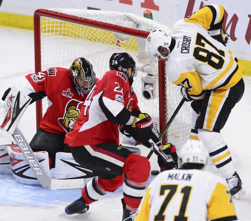 Pittsburgh Penguins' Sidney Crosby tucks the puck in the net past Ottawa Senators goalie Craig Anderson as Senators' Viktor Stalberg defends during the second period of Game 4 of the NHL hockey Stanley Cup Eastern Conference finals Friday in Ottawa, Ontario. (AP)