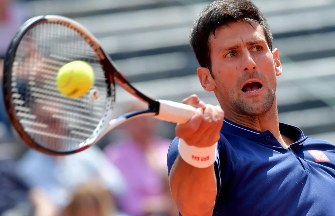 Novak Djokovic of Serbia hits a return to Juan Martin Del Potro of Argentina during quarterfinal match at the ATP Tennis Open tournament on Saturday at the Foro Italico in Rome. Djokovic won the rain-interrupted match 6-1, 6-4. (AFP)
