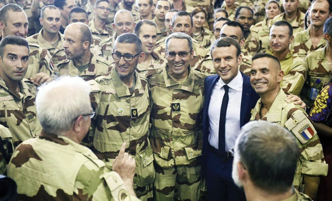 French President Emmanuel Macron with French troops during his visit to France's Barkhane counterterrorism operation in Africa's Sahel region in Gao, northern Mali. (AFP)