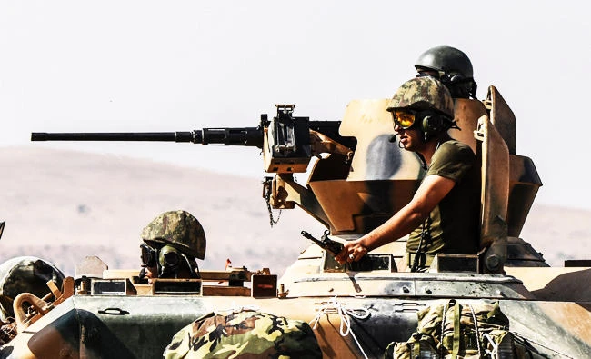Turkish soldiers seat in a tank driving to Syria from the Turkish Syrian border city of Karkamis in the southern region of Gaziantep, in this August 27, 2016 file photo. Turkey shelled Kurdish militia fighters in Syria on August 26 on the second day of(AFP)