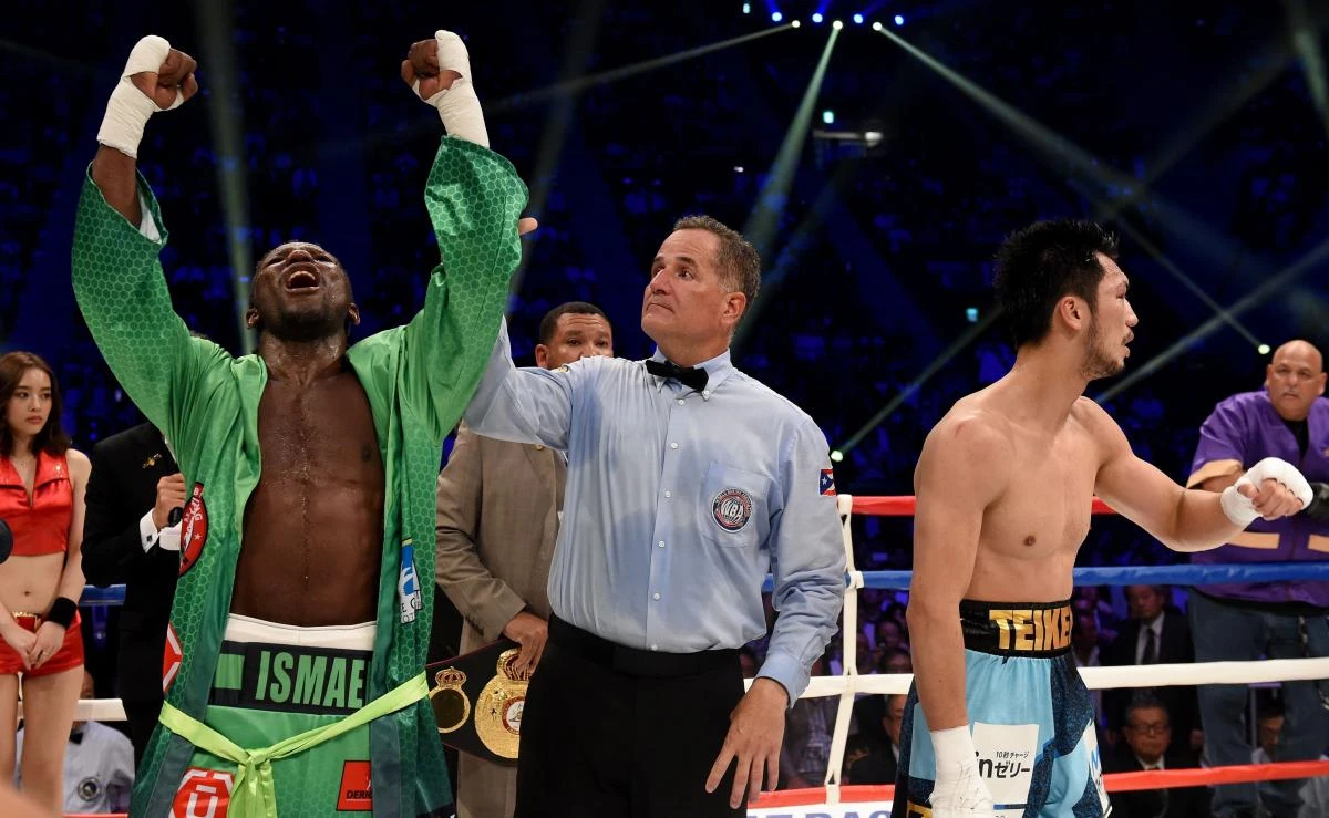 Hassan N'Dam of France, left, celebrates his victory over Ryota Murata of Japan after the 12th round of the WBA middleweight title bout in Tokyo on Saturday. (AFP)