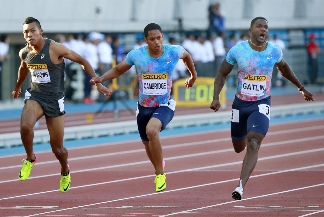 Justin Gatlin, right, of the US, crosses the finish line ahead of Aska Cambridge, center, and Abdul Hakim Sani Brown of Japan to win the men's 100 meters at the Golden Grand Prix track and field event in Kawasaki, near Tokyo, Sunday. (AP)