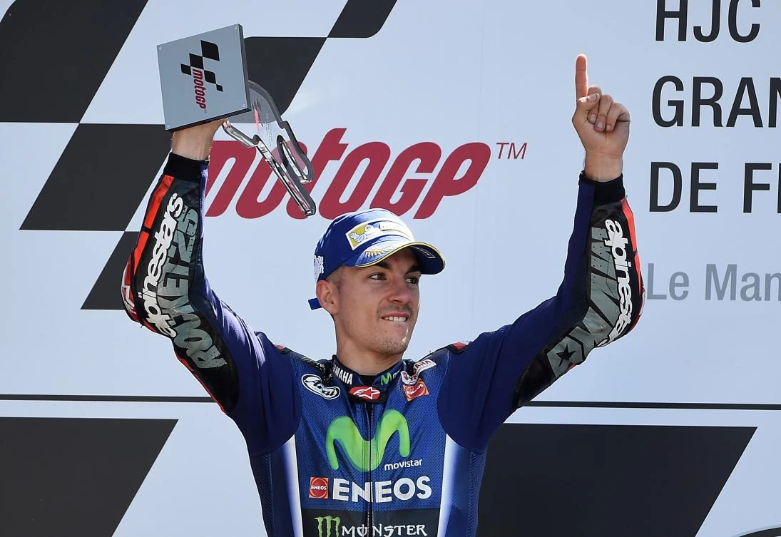 Winner Spanish's rider Maverick Vinales jubilates on the podium at the MotoGP race of the French Motorcycle Grand Prix on Sunday in Le Mans, northwestern France. (AFP)
