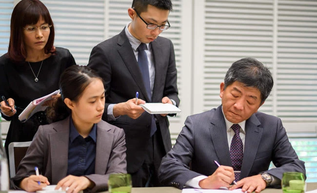 Taiwan's Minister of Health and Welfare Chen Shih-chung (R) works with assistants on Sunday in Geneva. Taiwan said on May 16, 2017 it had been excluded from a major World Health Organizsation meeting, the World Health Assembly (WHA), for the first time in eight years and blamed rival China for the snub as relations worsen. (AFP / Fabrice Coffrini)