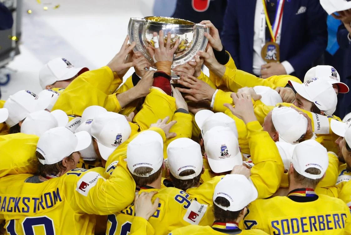 Sweden's players celebrate with the trophy after winning the IIHF Men's World Championship Ice Hockey final match between Canada and Sweden in Cologne, western Germany, on Sunday. (AFP)