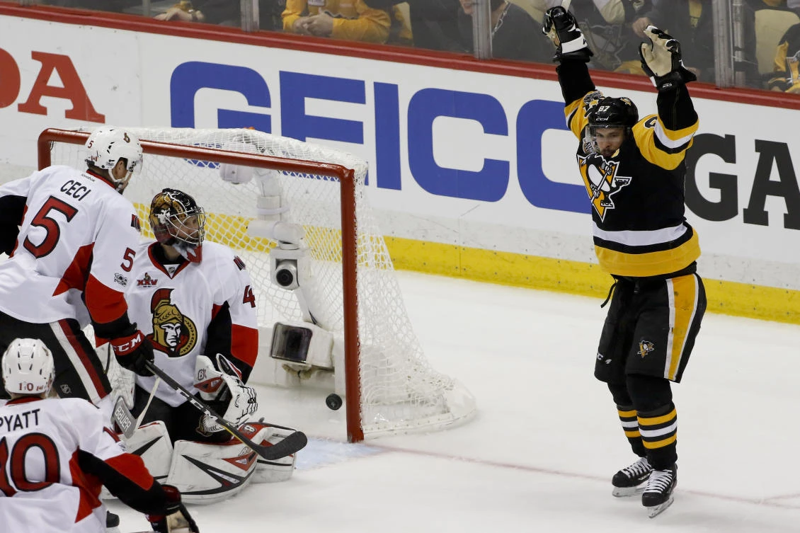 Pittsburgh Penguins' Sidney Crosby, right, celebrates after scoring on Ottawa Senators goalie Craig Anderson during the first period of Game 5 in the NHL hockey Stanley Cup Eastern Conference finals Sunday in Pittsburgh. (AP)