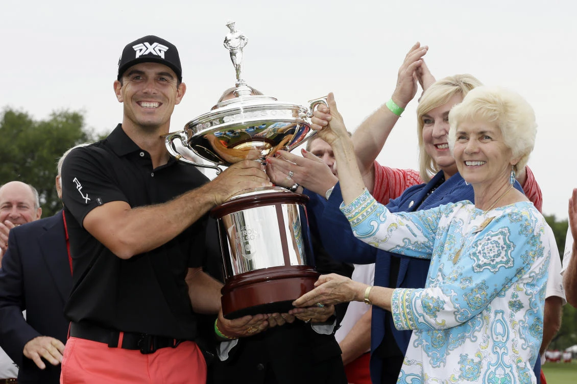 Billy Horschel is awarded the tournament trophy by Peggy Nelson, widow of Byron Nelson, after Horschel's win in the Byron Nelson golf tournament Sunday in Irving, Texas. (AP)