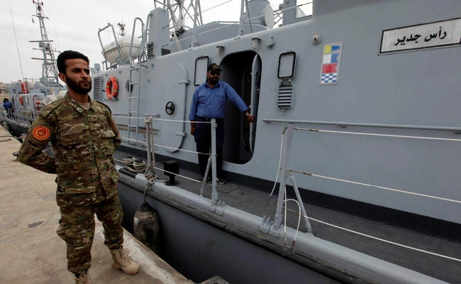 A member of the Libyan forces stands next to a boat that was repaired in Italy, after it was handed over to the Libyan navy at Tripoli naval base, Libya, on May 15, 2017. (REUTERS/Ismail Zitouny)