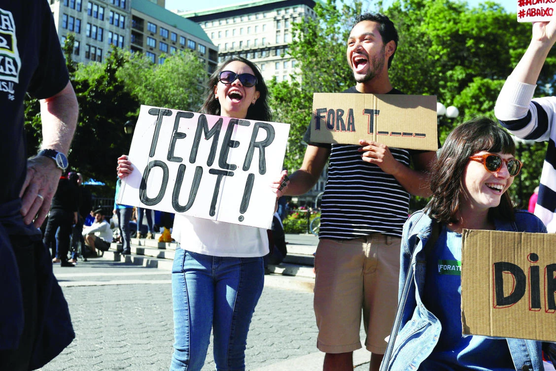 People demonstrate against Brazil's president Michel Temer during a protest in New York City. (Reuters)