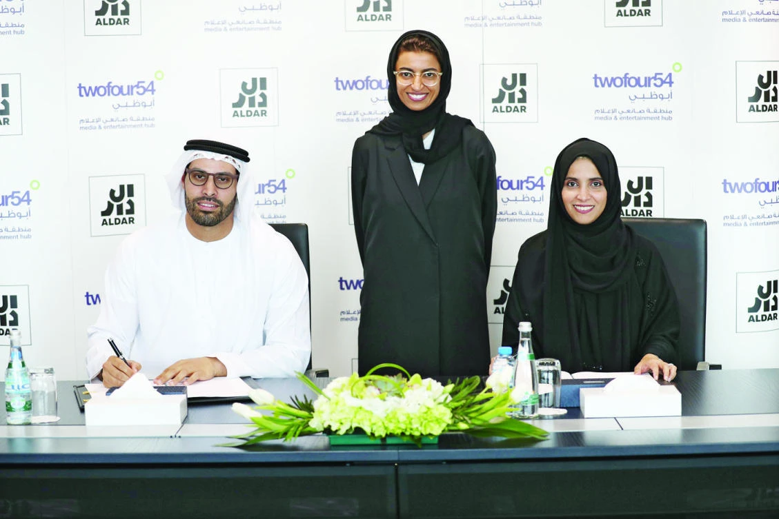 From left, Mohammed Khalifa Al-Mubarak, Noura Al-Kaabi and Maryam Al-Mheiri at the signing ceremony.