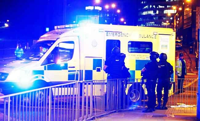 Armed police officers stand near the Manchester Arena, where U.S. singer Ariana Grande had been performing, in Manchester, in northern England, Britain on Tuesday. (REUTERS)