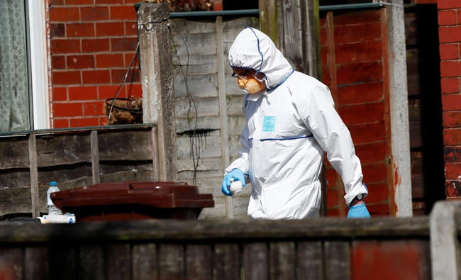 Police investigators work at residential property in south Manchester, Britain, on Tuesday. (REUTERS/Stefan Wermuth)