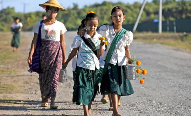 Girls walk to school at the outskirts of Yangon, Myanmar. (Reuters file photo)