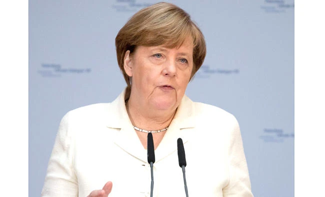 German Chancellor Angela Merkel delivers her speech on Tuesday in Berlin at the Petersberg Climate VIII Dialogue event. (AFP)