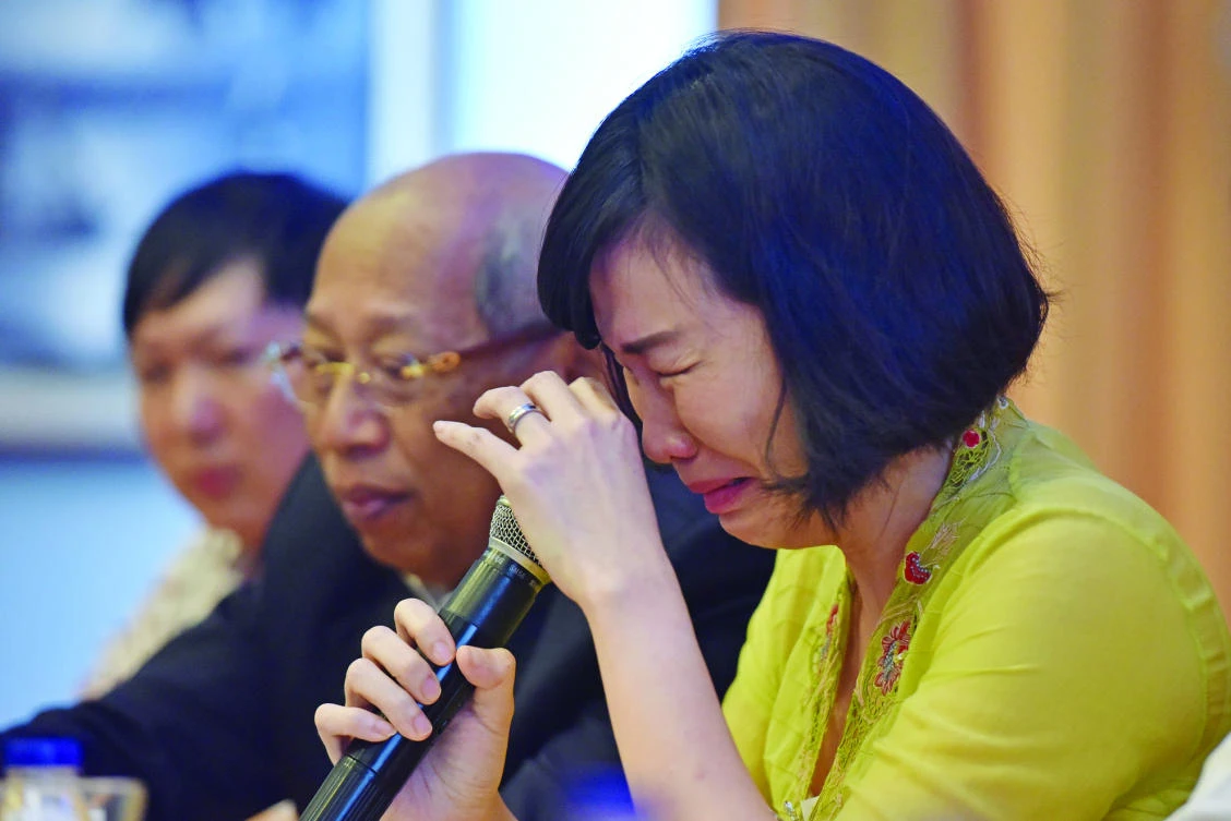 Veronica Tan, the wife of former Jakarta Gov. Basuki Tjahaja Purnama, weeps during a news conference in Jakarta. (Reuters)